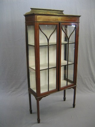 An Edwardian inlaid mahogany display cabinet with raised back, the interior fitted shelves enclosed by astragal glazed panelled doors, raised on square tapering supports ending in spade feet 31"