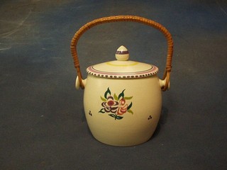 A circular Poole Pottery biscuit barrel and cover with floral decoration 5"