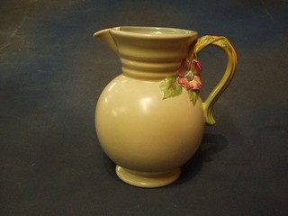 A circular Clarice Cliff jug, the handle in the form of flower heads, the base marked Clarice Cliff 895, 9"