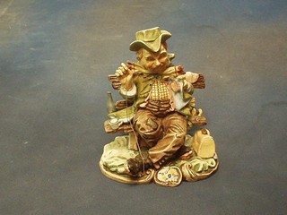 A Monte Cristo biscuit porcelain figure of a seated tramp 7"