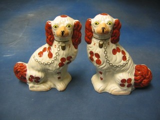 A pair of Wood Staffordshire style figures of seated spaniels 11"
