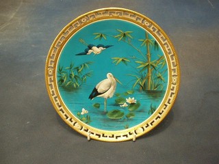 A handsome Victorian Minton circular porcelain plate decorated storks amidst reeds with gilt ribbon work border (slight chip to border), the base with kite mark 9 1/2"