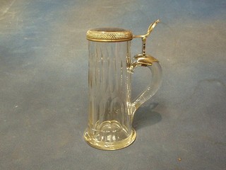A faceted glass beerstein with silver plated lid