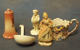 A Quimper chamber stick (f), 2 porcelain figures of a cherub and lady, a biscuit porcelain figure, a horn beaker and a pair of crested china salts decorated Arms of Woolwick