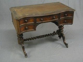 A Victorian rosewood dressing table of serpentine outline with inset tooled writing surface, fitted 4 short and 1 long drawer, raised on turned supports united by a spiral turned H framed stretcher 39"