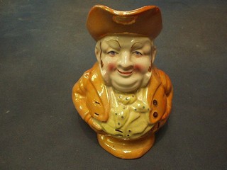 A 19th Century orange glazed Toby jug in the form of Toby Philpot