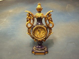 An 18th Century style mantel clock contained in urn shaped case