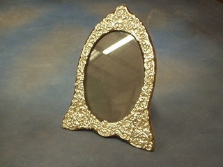 A modern embossed silver easel photograph frame of oval form 30"