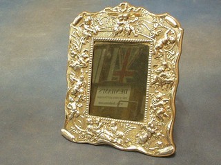 A handsome modern embossed silver easel photograph frame decorated cherubs 9"