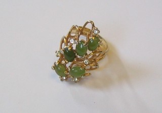 An 18ct gold dress ring inset green cabouchon cut stones and diamonds
