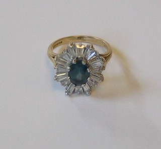 A 9ct gold dress ring set a blue stone supported by cubic zirconians