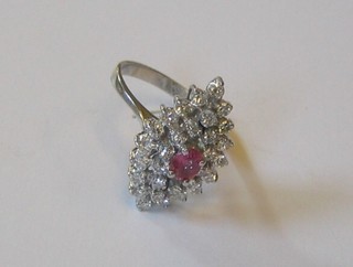A lady's very attractive 18ct white gold dress ring of marquese form set pink sapphires and numerous diamonds
