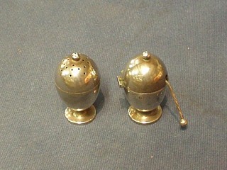 A silver mustard of egg form with hinged lid, (liner and hinge f) together with a matching pepper, Birmingham 1920