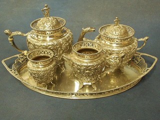 An Eastern embossed silver Bachelor's 5 piece tea service comprising engraved oval twin handled tray, teapot, sucrier and cover, cream jug and 1 other embossed vase, finials in the form of standing men 35 ozs