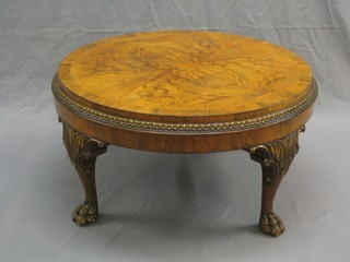 A 1920's Queen Anne style circular figured walnut and crossbanded occasional table, raised on carved claw and ball supports, 30"