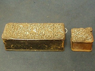 An Edwardian rectangular leather stamp box with embossed silver lid 3 1/2" (some holes) and a square ditto 1" (some damage)