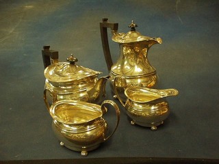 A Georgian style 4 piece silver tea service of oval form, raised on bun feet comprising teapot, twin handled sugar bowl and cream jug, Birmingham 1913, 54 ozs