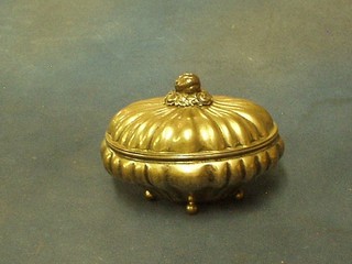 A Continental oval embossed silver box with hinged lid, raised on bun feet, 10 ozs