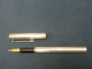 A "silver" cased Dunhill fountain pen, the gold nib marked Dunhill 585