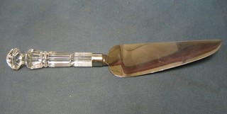 A chromium plated cake slice with faceted glass handle
