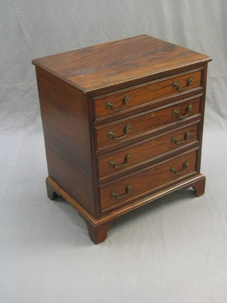 A reproduction Georgian mahogany chest of 4 long drawers with brass swan neck drop handles, raised on bracket feet 26" (crack to top)