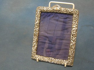 An Edwardian embossed silver easel photograph frame Birmingham 1900 (some holes) 7"