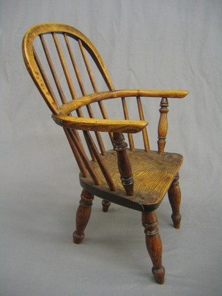 A 20th Century childs elm stick and rail back chair with solid seat (split to seat and old repair to back rail)