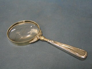 A circular magnifying glass (slight chip) with silver handle (marks rubbed)