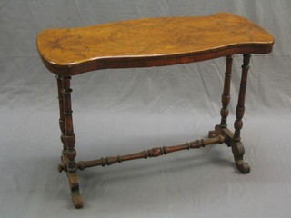 A Victorian figured walnut sofa table of serpentine outline raised on turned supports united by an H framed stretcher (top recently polished and with some pitting) 39"