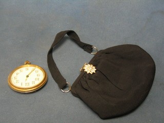 An 8 day travelling clock (f) and a lady's evening bag