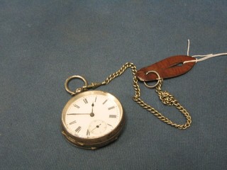 An open faced pocket watch contained in a Continental silver case, marked 935, hung on a chain