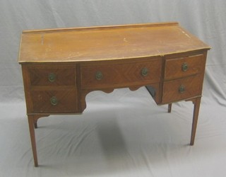 An Edwardian inlaid mahogany bow front dressing table fitted 1 long drawer flanked by 2 short drawers (some damage to the front), raised on square tapering supports 48"