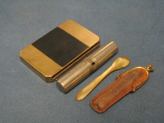 A Japanese gilt metal compact, an amber cigarette holder and a steel screwdriver set