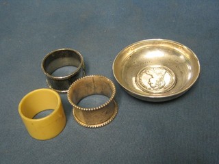 2 silver napkin rings, a horn  napkin ring and a silver dish decorated a Mary Teresa coin