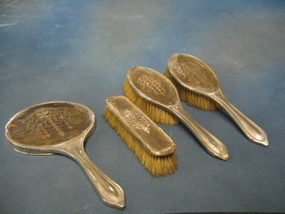 A 4 piece silver and tortoiseshell backed dressing table set comprising 2 hair brushes, clothes brush and hand mirror London 1917 