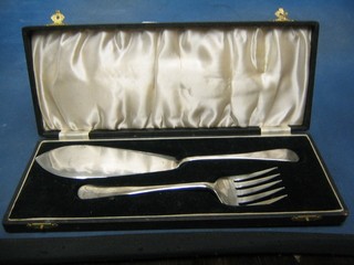 A pair of silver plated fish servers, cased
