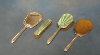 An Art Deco silver and green enamelled 4 piece dressing table set comprising 2 hair brushes, hand mirror and clothes brush with 1934 Jubilee hallmark (marks rubbed)
