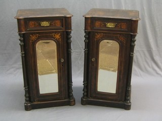 A pair of Victorian inlaid walnut pedestal cabinets fitted a drawer above cupboard enclosed by an arched plate mirror, having 2 columns to the sides 20" (formerly part of a sideboard)