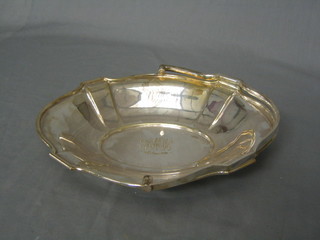 An Edwardian oval silver plated cake basket with swing handle, inscribed