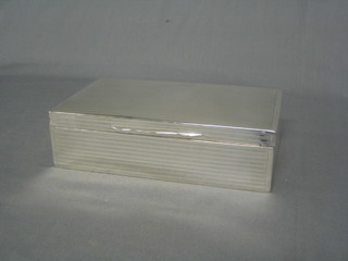 A rectangular silver cigarette box with engine turned decoration (marks rubbed) 9"