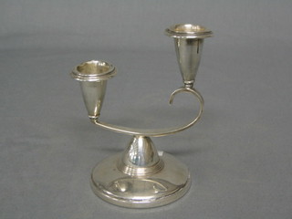 A modern silver twin light candelabrum raised on a spreading foot, 4"