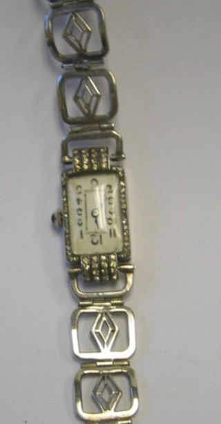 A lady's cocktail wristwatch contained in a "silver " case 
