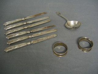 2 silver napkin rings, a silver tea strainer and 6 silver handled tea knives