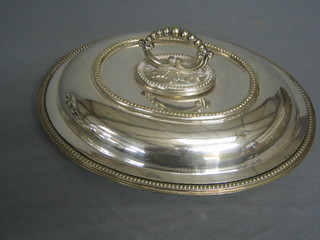 An oval silver plated entree dish and cover