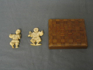 A pair of Oriental carved ivory figures of standing merchants 2" (f) and an Oriental parquetry box with hinged lid 3 1/2" (3)