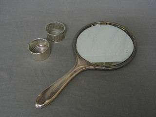 A silver hand mirror with engine turned decoration and 2 silver napkin rings