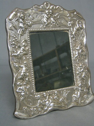 A handsome modern embossed silver easel photograph frame decorated cherubs 9"