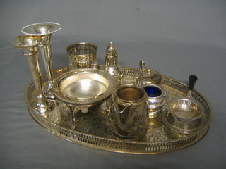 A modern silver plated oval galleried tea tray, a 3 piece silver plated condiment set, a tea strainer, cream jug, 2 specimen vases, a silver plated butter dish and cover and other silver plated items
