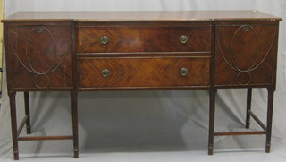 A Georgian style mahogany sideboard, fitted 2 long drawers flanked by a pair of cupboards, raised on turned and reeded supports 72"
