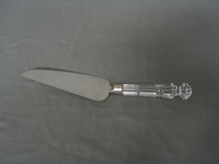 A chromium plated cake slice with faceted glass handle